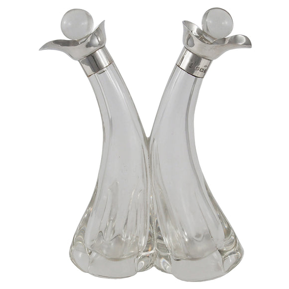 An Edwardian, glass oil & vinegar cruet with silver mounts & glass stoppers