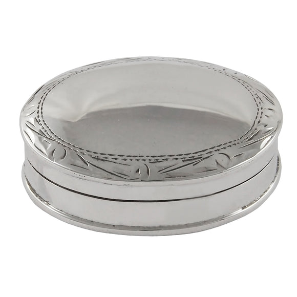 A modern, silver, oval pill box