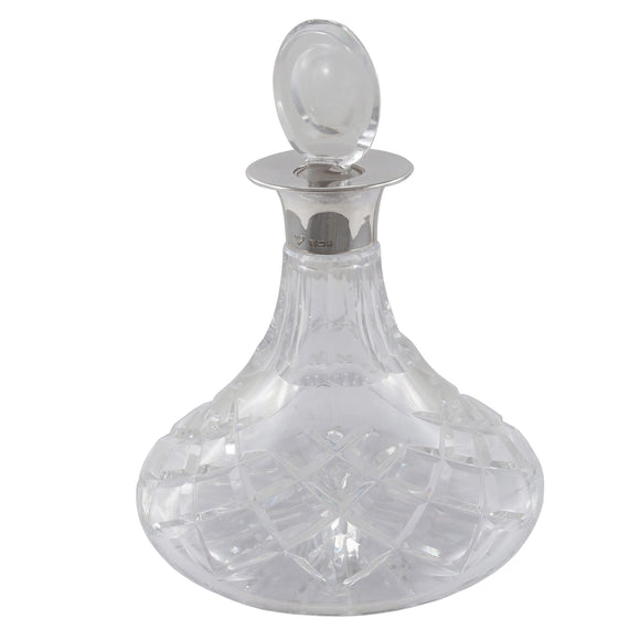 A modern, cut glass ships decanter with a silver mount