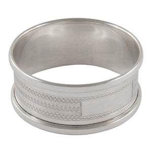 A mid-20th century, silver napkin ring with engine turned design & vacant cartouche.