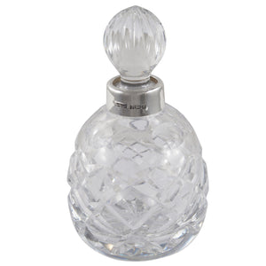 A modern, cut glass scent bottle with a silver mount