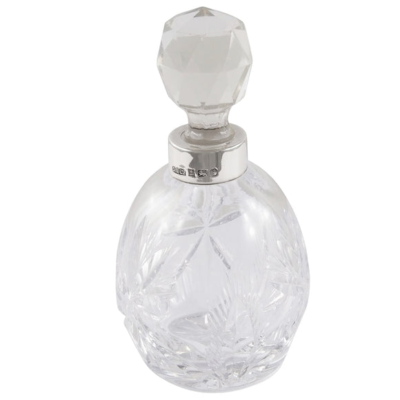 A modern, cut glass scent bottle with a silver mount.