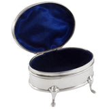 An Edwardian, silver, plain, oval trinket box on four feet.