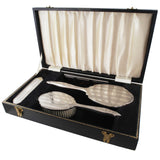 A modern, silver, four piece brush set & fitted case.