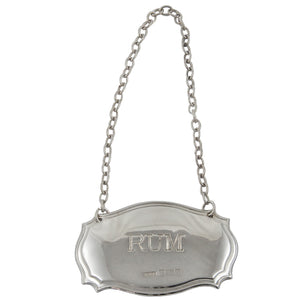 A modern, silver, rum decanter label.