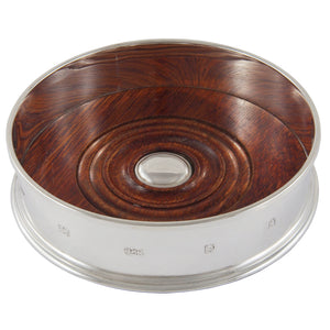 A modern, silver &amp; wood decanter coaster.