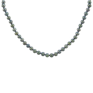 A modern, single row of black cultured pearls on a silver magnetic snap