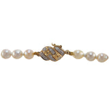 A single row of Baroque Akoya pearls on a 14ct yellow gold, diamond set snap