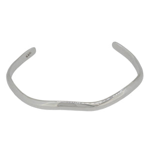 A modern, silver wave bangle