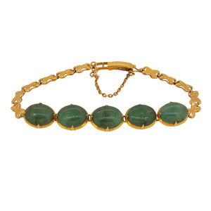 A modern, yellow metal, jadeite set, five stone in line bracelet