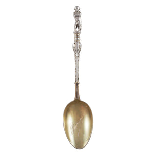 An early 20th century, French, white metal teaspoon with an image of Napoleon Bonaparte on the handle & the word 'Paris' engraved in the gilded bowl